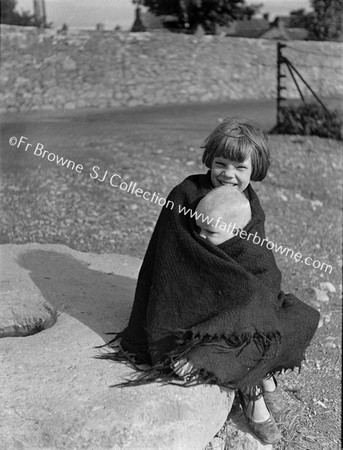 PORTRAIT OF LITTLE GIRL WITH BABY